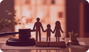 A silhouette of a family stands between a judge's gavel and a scale of justice, representing family law.